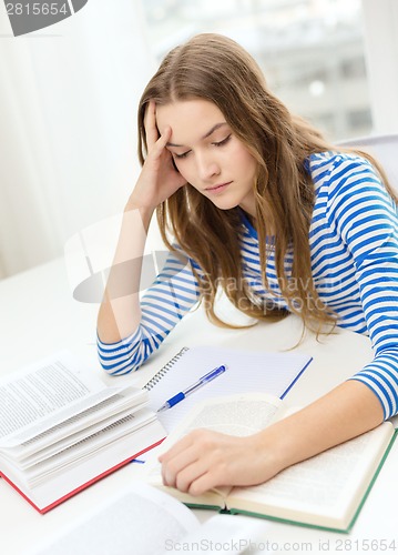 Image of stressed student girl with books