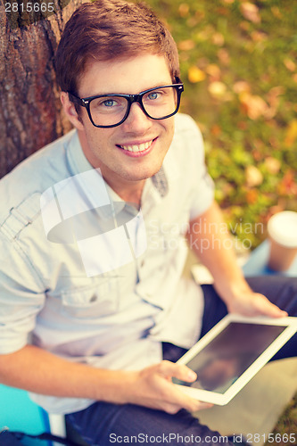 Image of smiling male student in eyeglasses with tablet pc