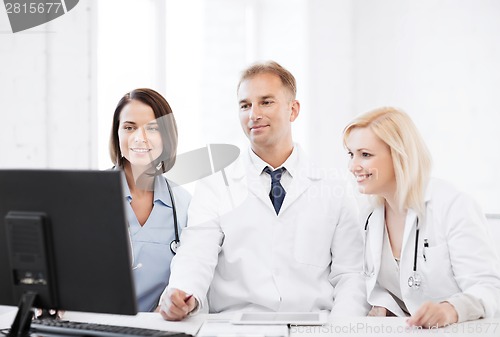 Image of doctors looking at computer on meeting
