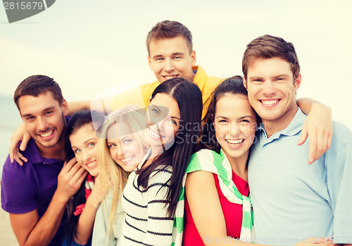 Image of group of friends having fun on the beach