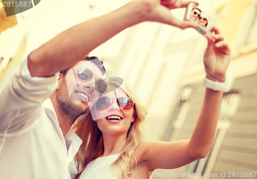 Image of travelling couple taking photo picture with camera