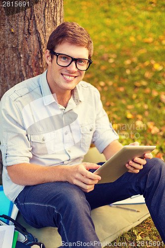 Image of smiling male student in eyeglasses with tablet pc