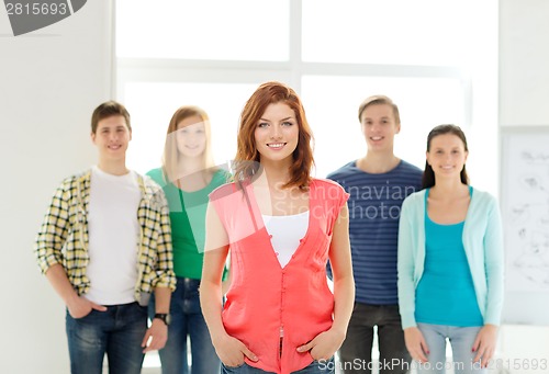 Image of smiling students with teenage girl in front