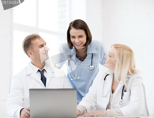 Image of group of doctors looking at tablet pc