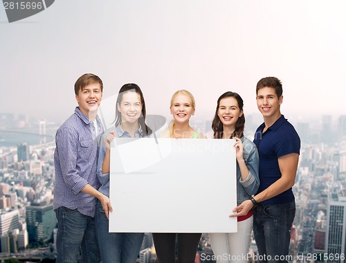 Image of group of standing students with blank white board