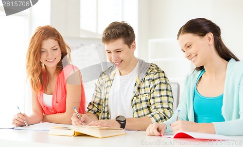 Image of students with textbooks and books at school