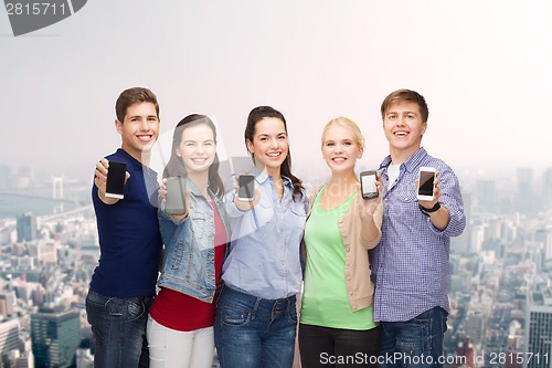 Image of students showing blank smartphones screens