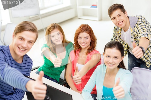 Image of group of smiling students showing thumbs up