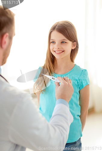 Image of male doctor with child measuring temperature