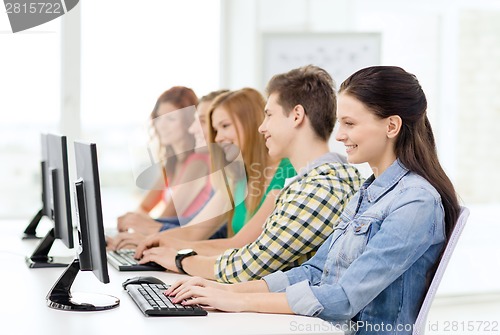 Image of female student with classmates in computer class