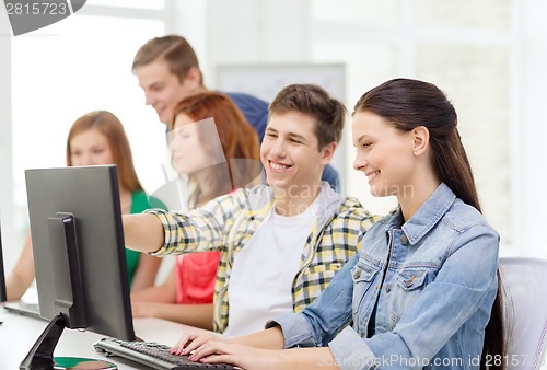 Image of female student with classmates in computer class