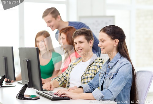 Image of female student with classmates in computer class