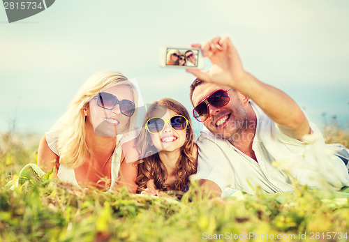Image of happy family with camera taking picture