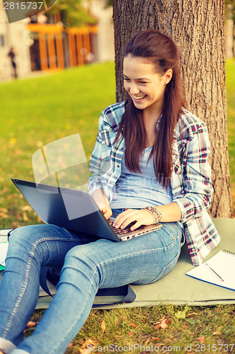 Image of smiling teenager with laptop