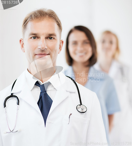 Image of doctor with stethoscope and colleagues