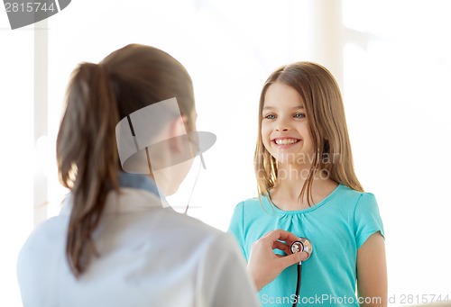 Image of female doctor with stethoscope listening to child