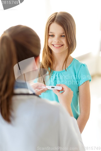 Image of female doctor with child measuring temperature