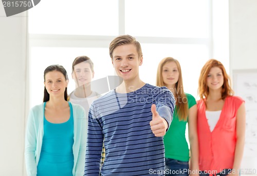 Image of smiling students with teenage boy in front