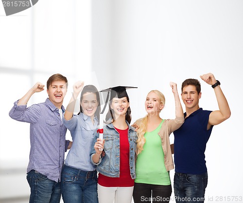 Image of group of standing smiling students with diploma