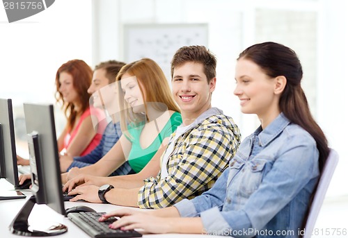 Image of smiling student with computer studying at school