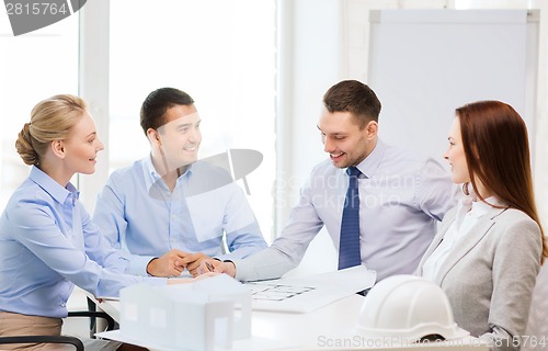 Image of happy team of architects and designers in office