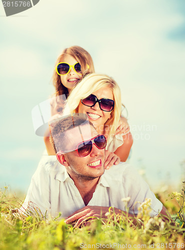 Image of happy family with blue sky and green grass