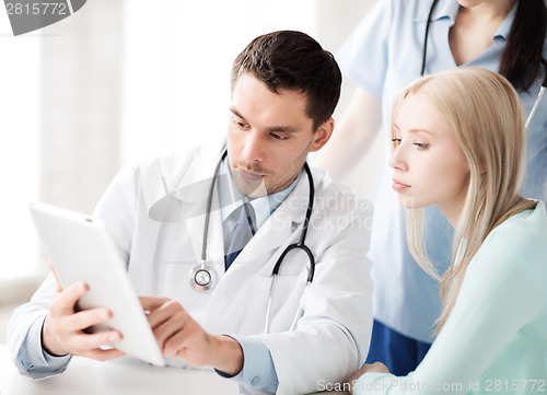 Image of doctor and nurse with patient in hospital