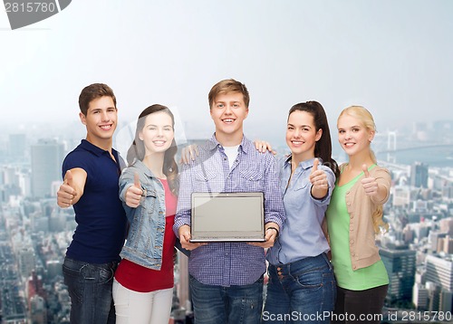 Image of smiling students with laptop computer