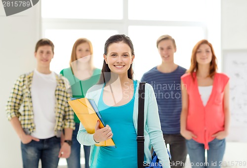 Image of smiling students with teenage girl in front