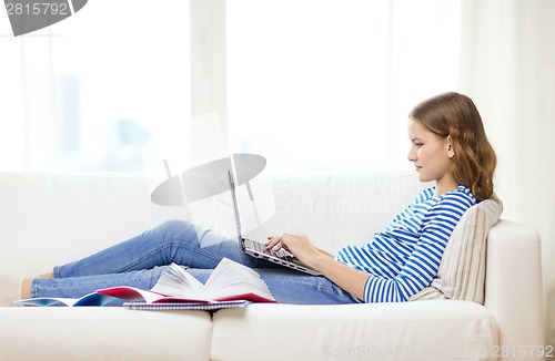 Image of busy teenage girl with laptop computer at home