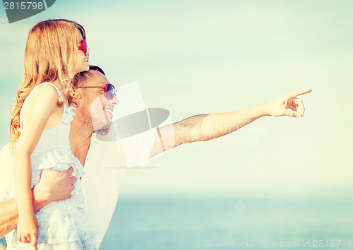Image of happy father and child in sunglasses over blue sky