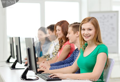 Image of female student with classmates in computer class