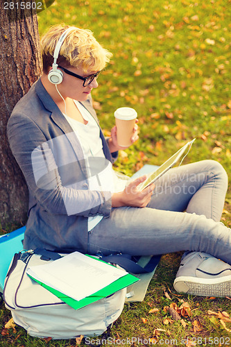 Image of smiling male student in eyeglasses with tablet pc