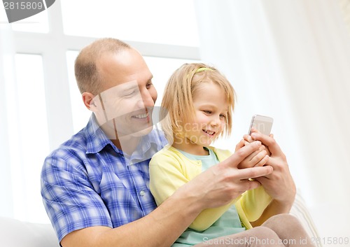 Image of happy father and daughter with smartphone