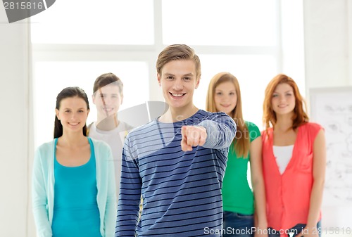 Image of students with teenager in front pointing at you