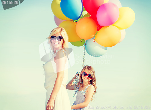 Image of mother and child with colorful balloons