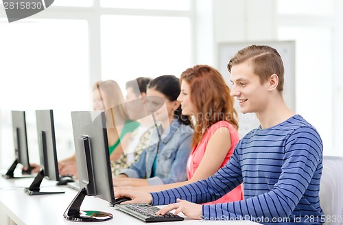 Image of male student with classmates in computer class