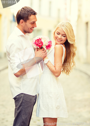 Image of couple with flowers in the city