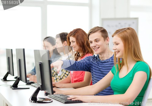 Image of female student with classmates in computer class