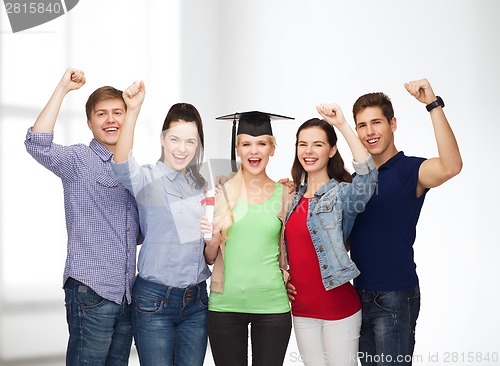 Image of group of standing smiling students with diploma