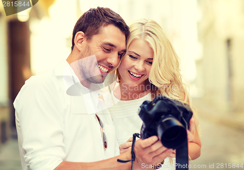 Image of smiling couple with photo camera