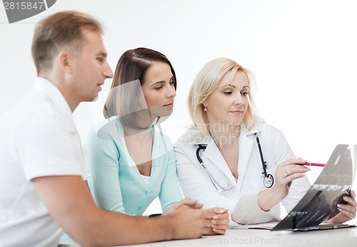Image of doctor with patients looking at x-ray