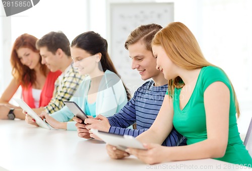 Image of smiling students with tablet pc at school