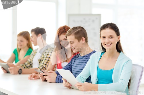 Image of smiling students with tablet pc at school