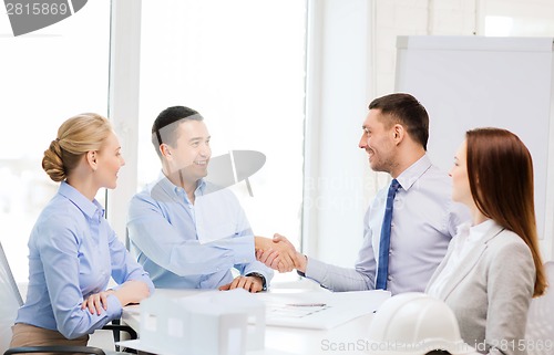 Image of happy team of architects and designers in office