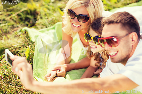 Image of happy family with camera taking picture