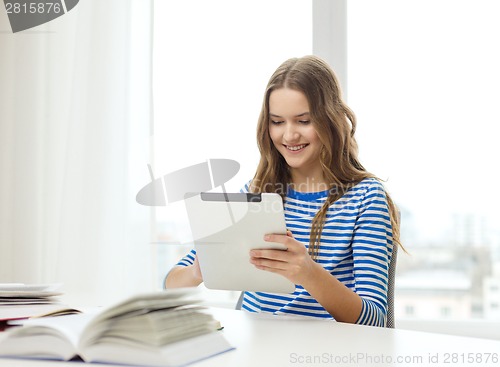 Image of smiling student girl with tablet pc and books