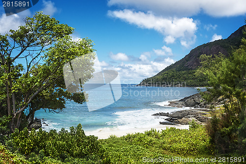 Image of Small sandy beach between volcanic rocks