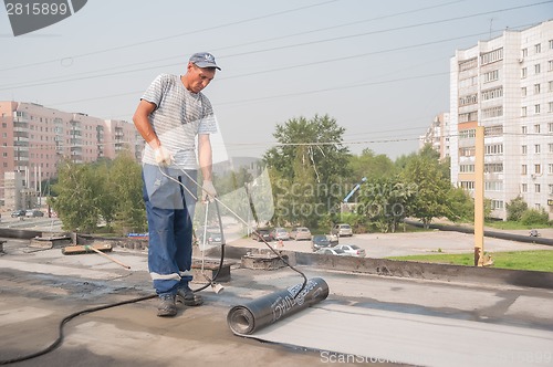 Image of Worker make waterproofing of seams on bridge