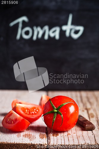 Image of fresh tomatoes and blackboard 